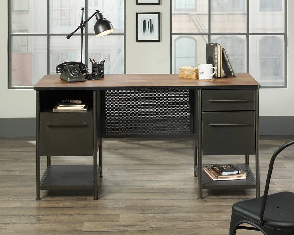 Black office desk in large studio apartment setting