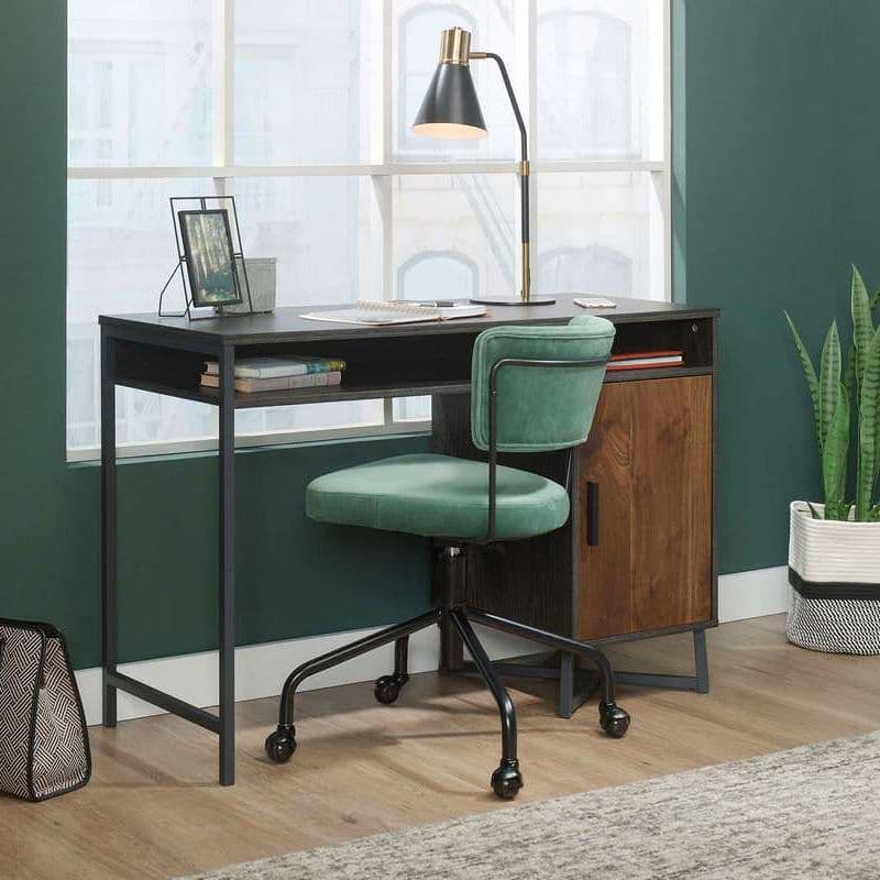 Office desk at a large window with a small green chair