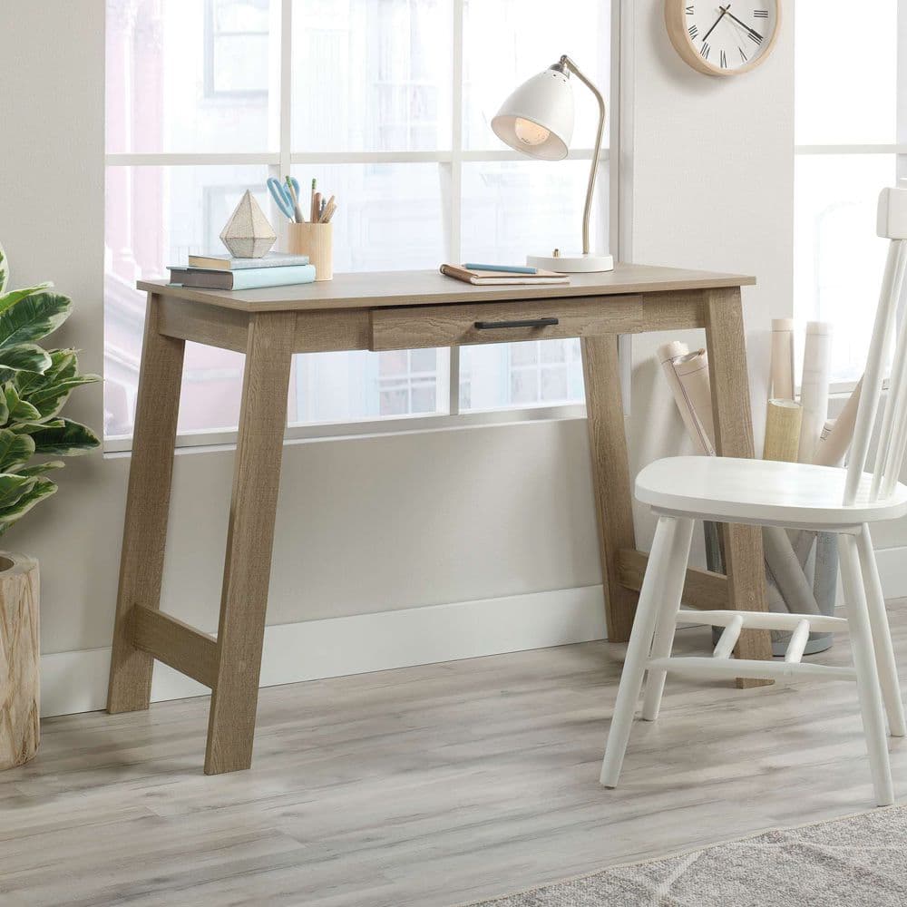 a wooden desk with a clock on the wall