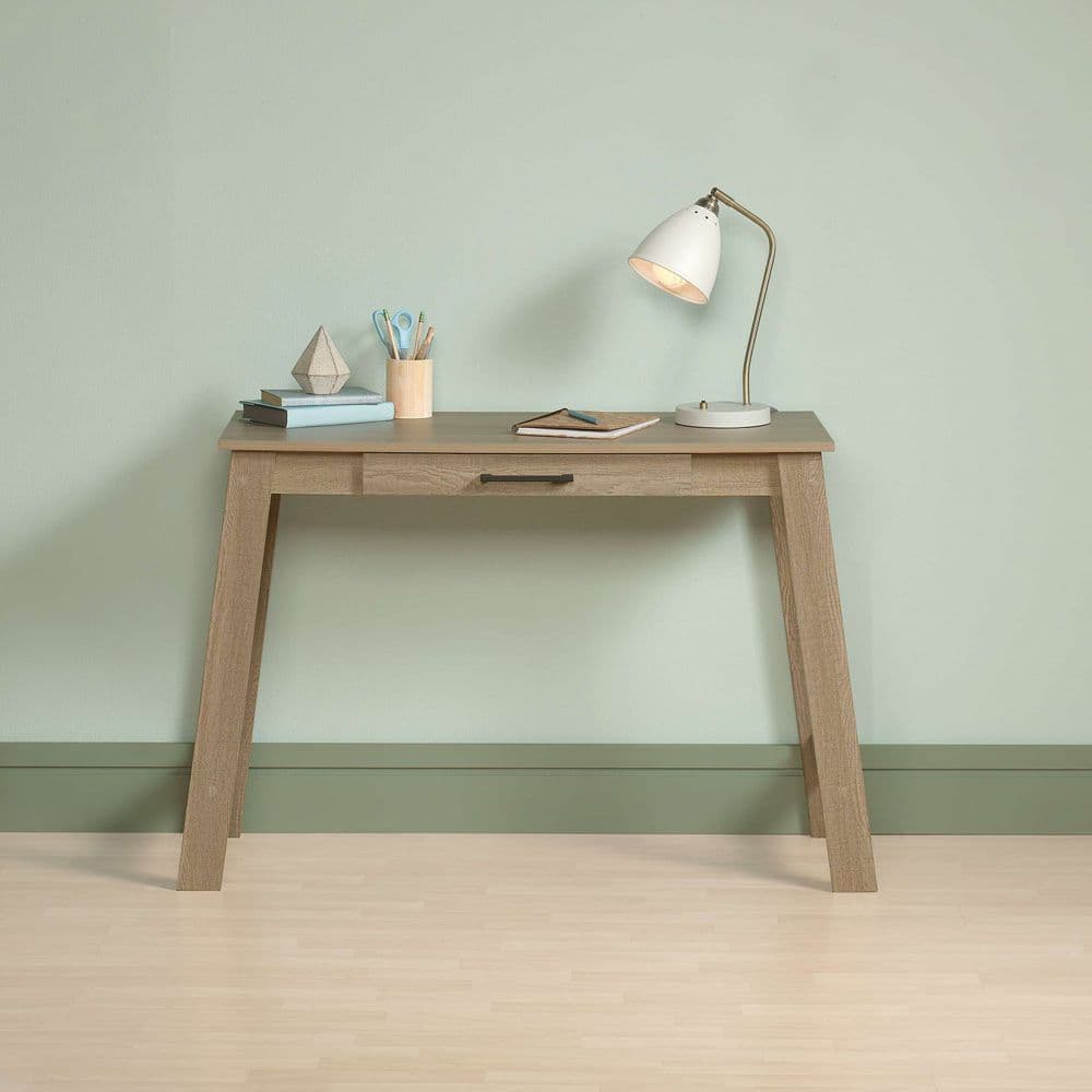 a wooden desk with a lamp on top of it