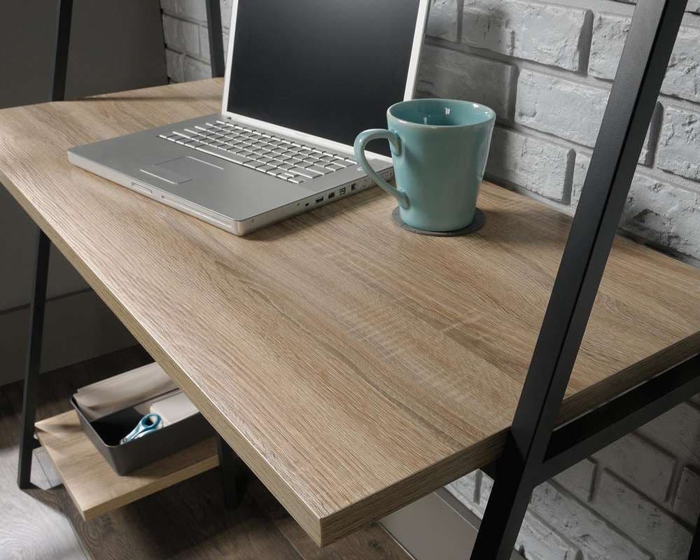 a laptop computer sitting on top of a wooden desk