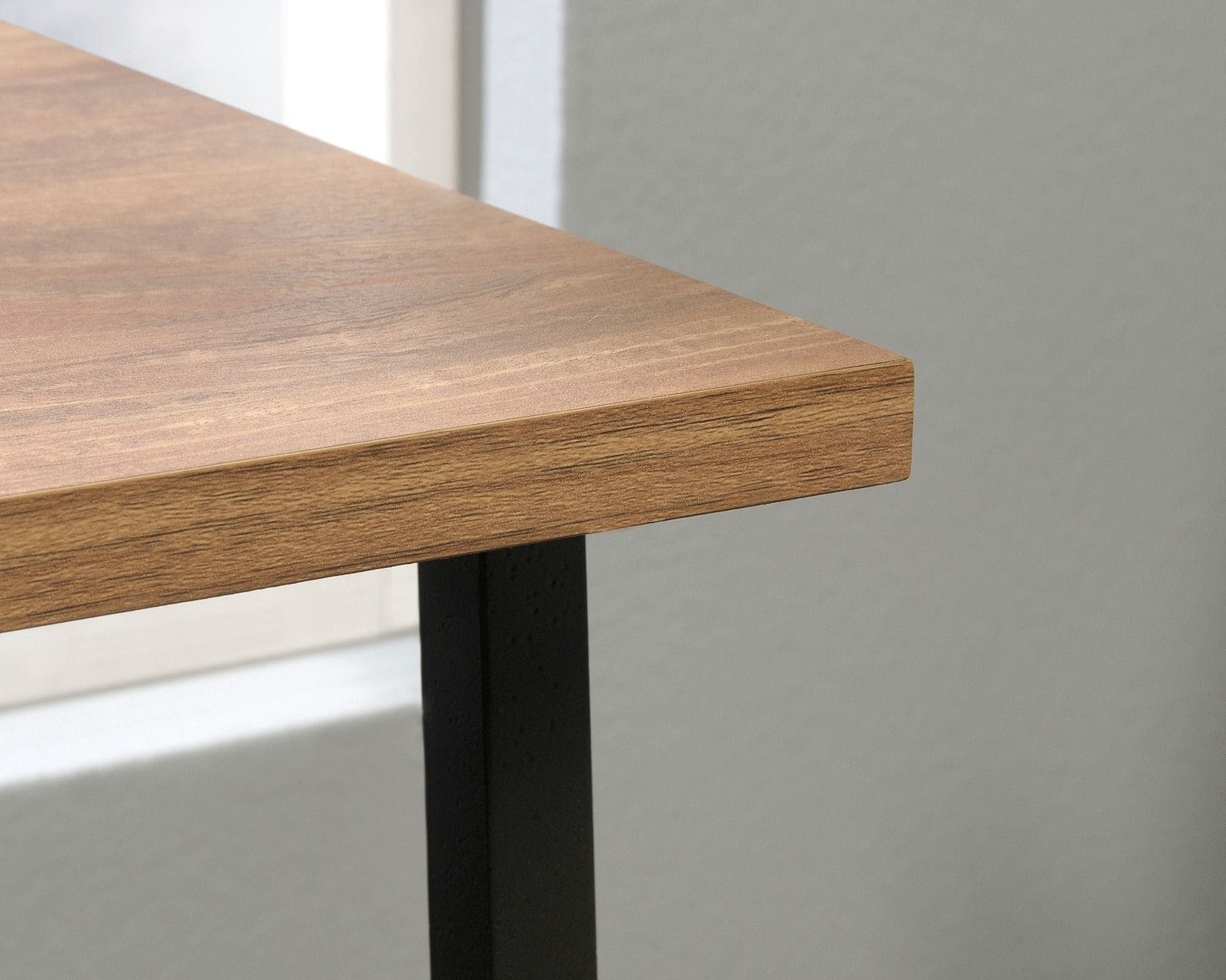 a close up of a wooden table with metal legs