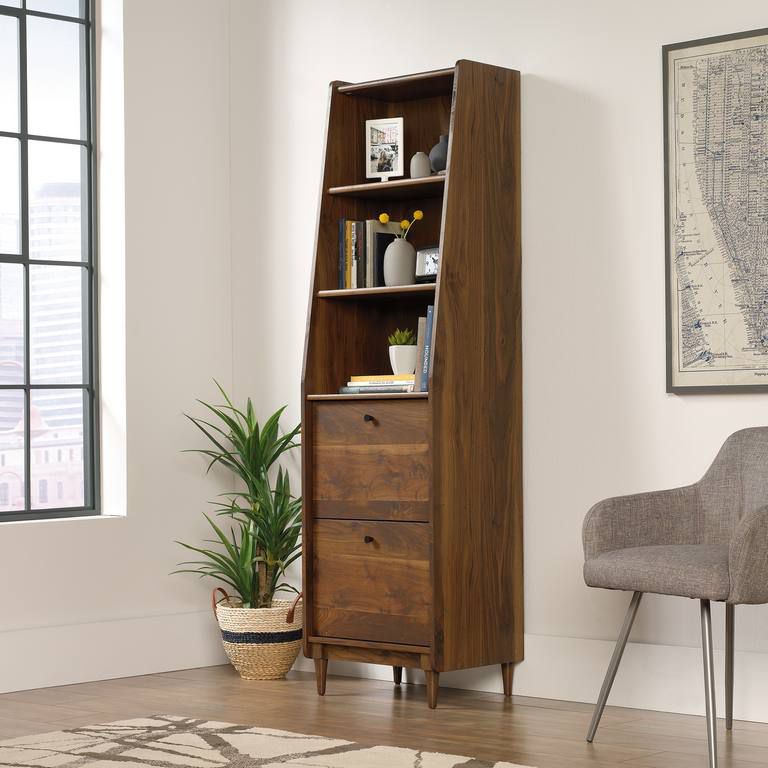 a tall wooden bookcase with drawers in a living room