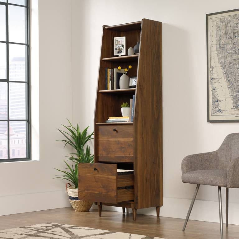 a tall bookcase with drawers in a living room