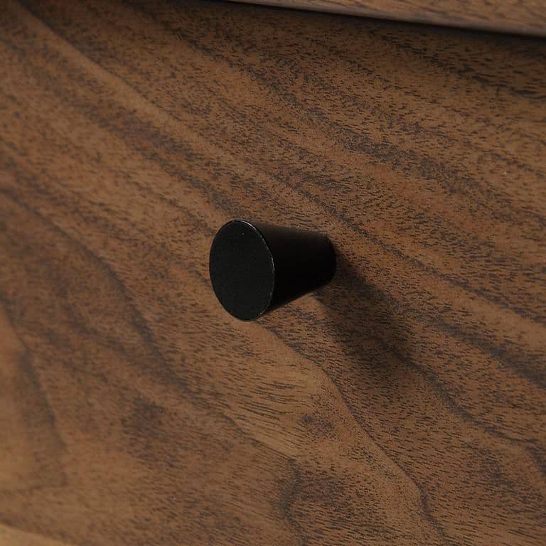 a close up of a wooden drawer with a black knob