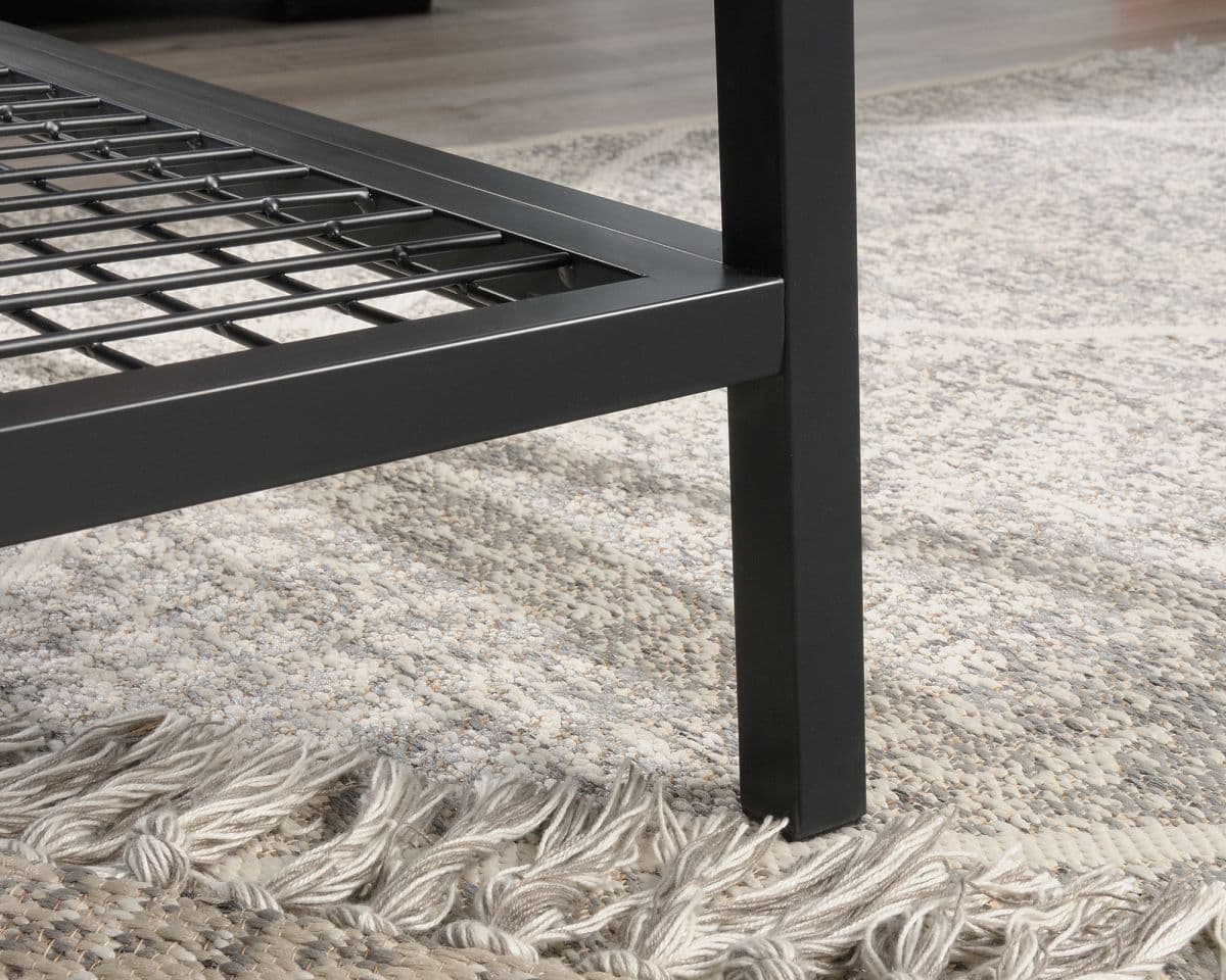 a close up of a metal bed frame on a rug