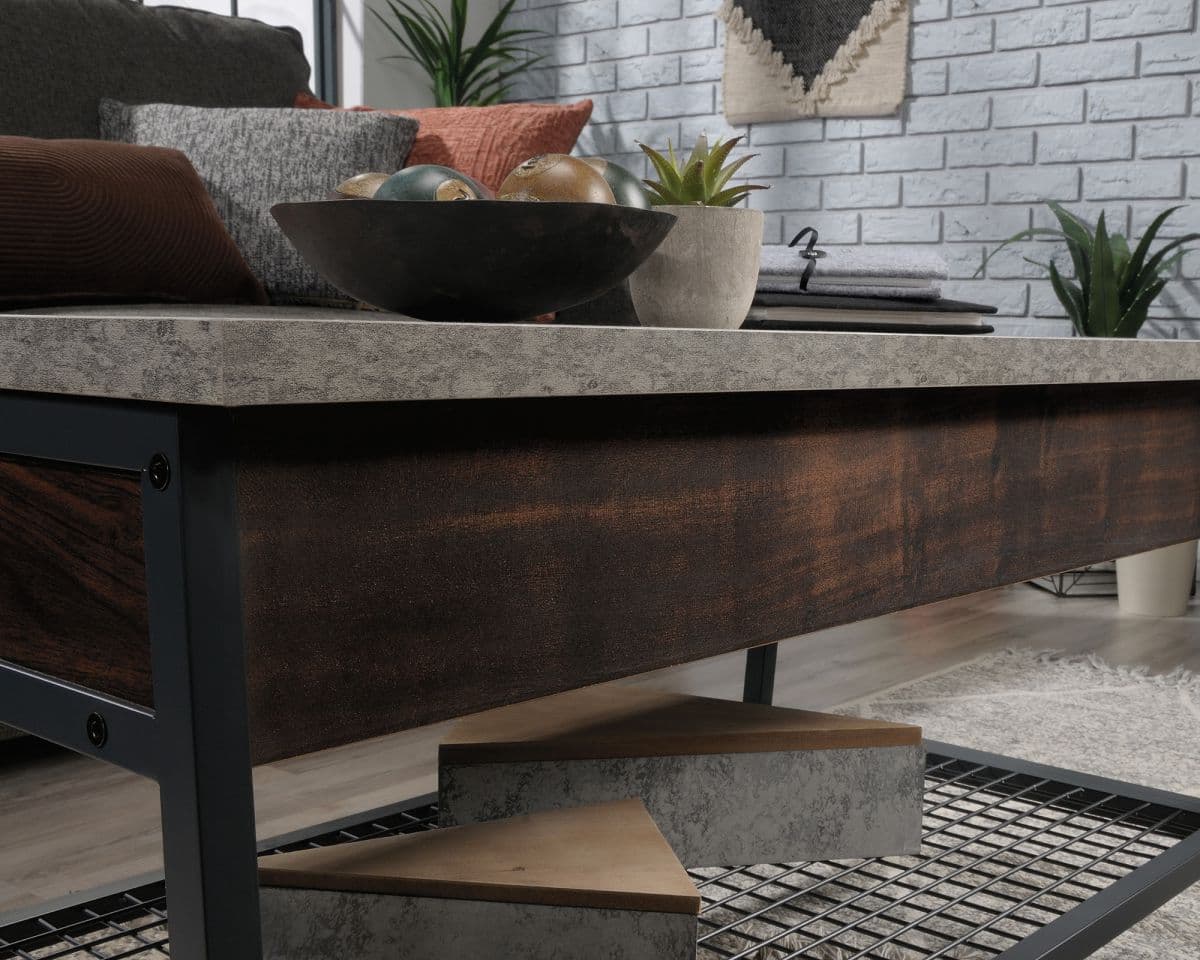 a coffee table with a metal shelf and a bowl on top of it