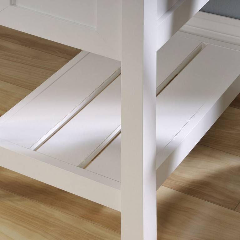 a close up of a white table on a wooden floor