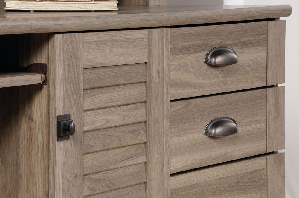 a close up of a dresser with a book on top of it