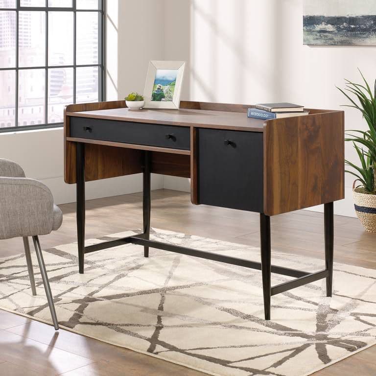 a desk with a chair and a potted plant