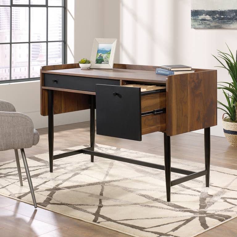 a desk with a chair and a potted plant