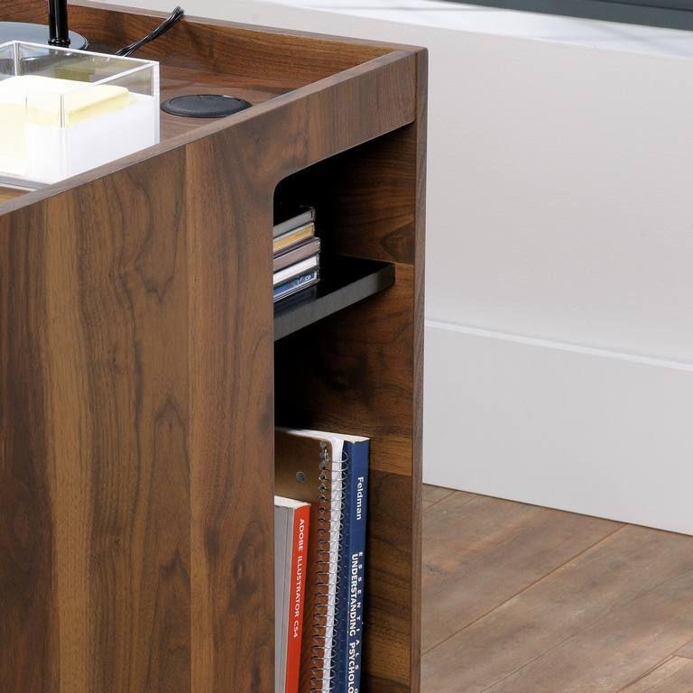 a desk with a book shelf and a lamp on top of it