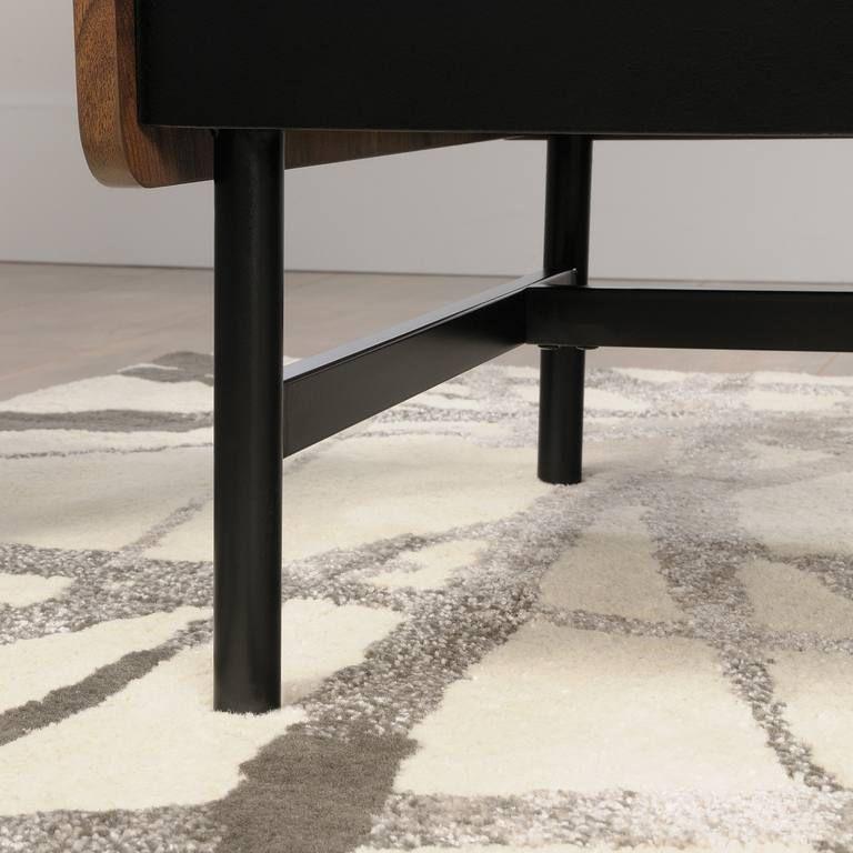 a close up of a chair with a rug on the floor