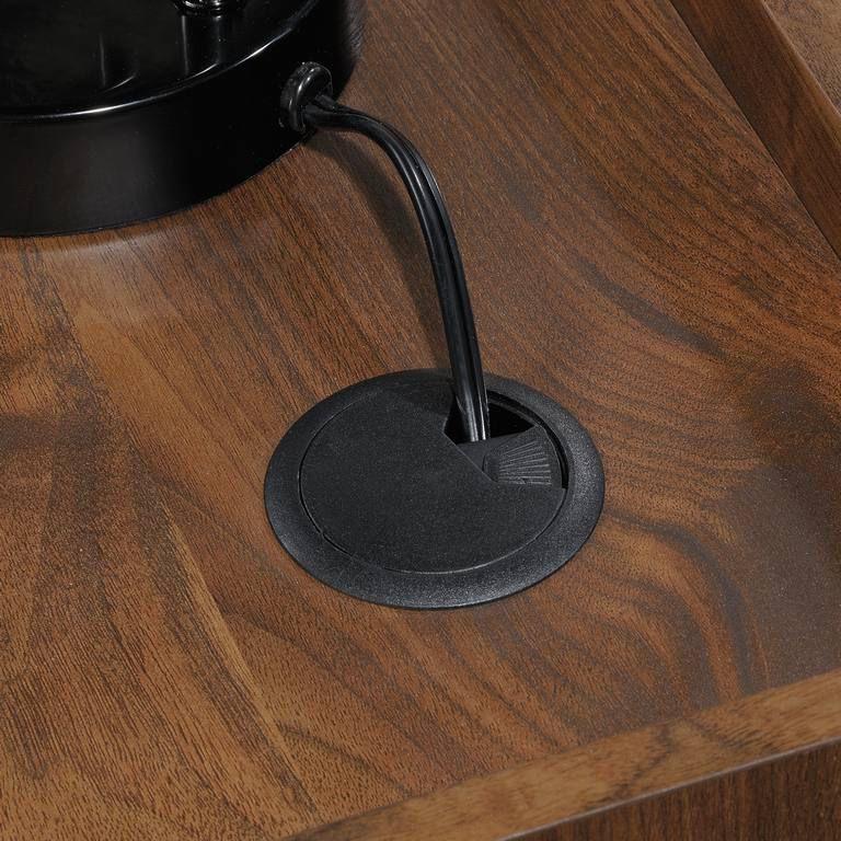 a close up of a wooden table with a black object on it