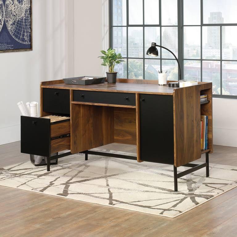 a wooden desk with a lamp on top of it