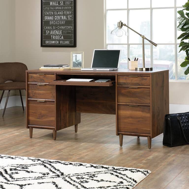 a wooden desk with a laptop on top of it