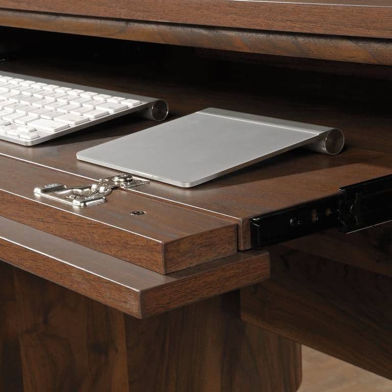 a wooden desk with a keyboard and mouse