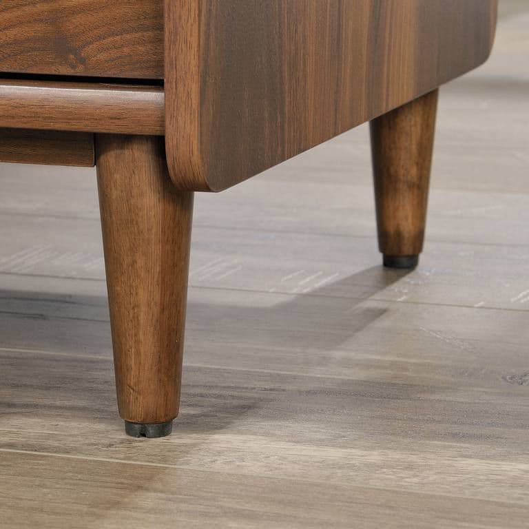 a close up of a wooden table on a tile floor