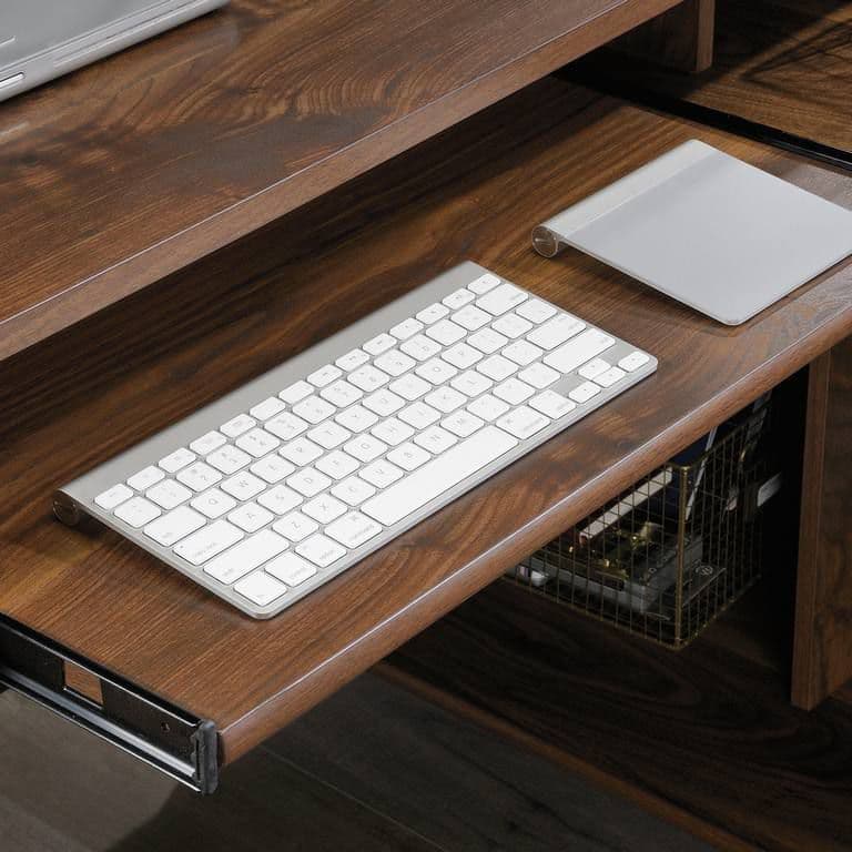 a wooden desk with a keyboard and mouse