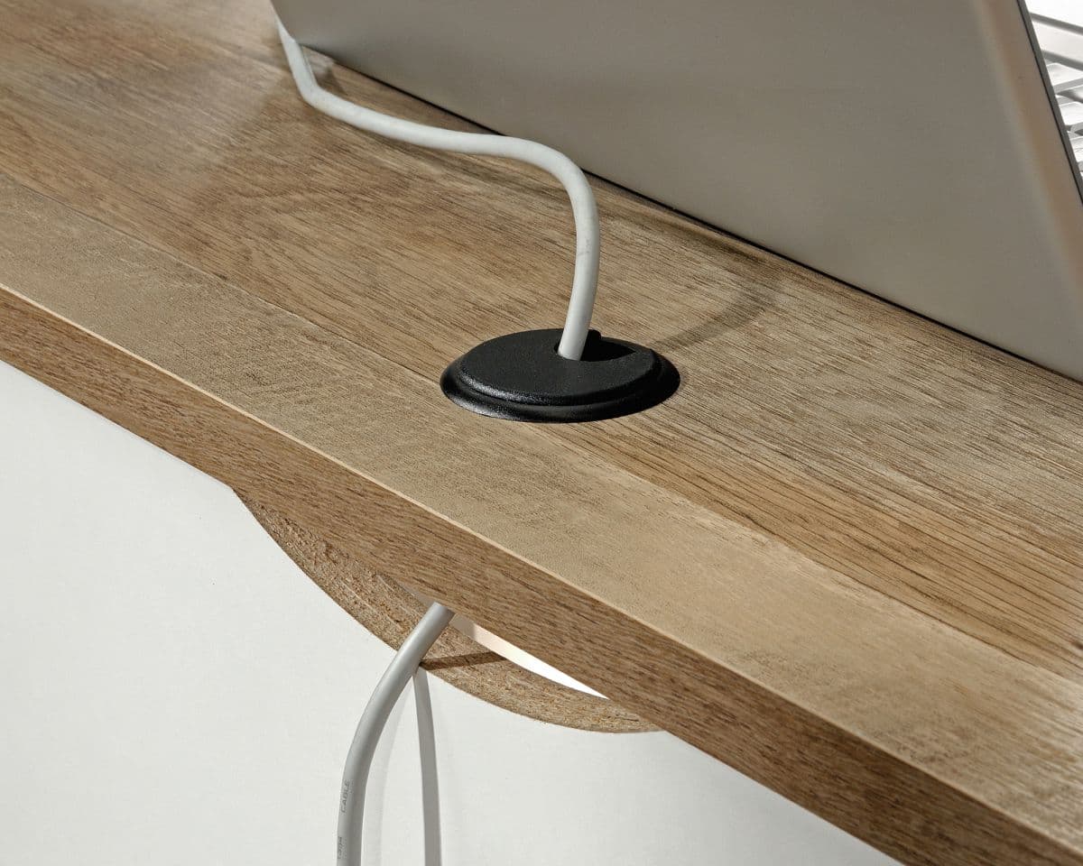 a laptop computer sitting on top of a wooden desk