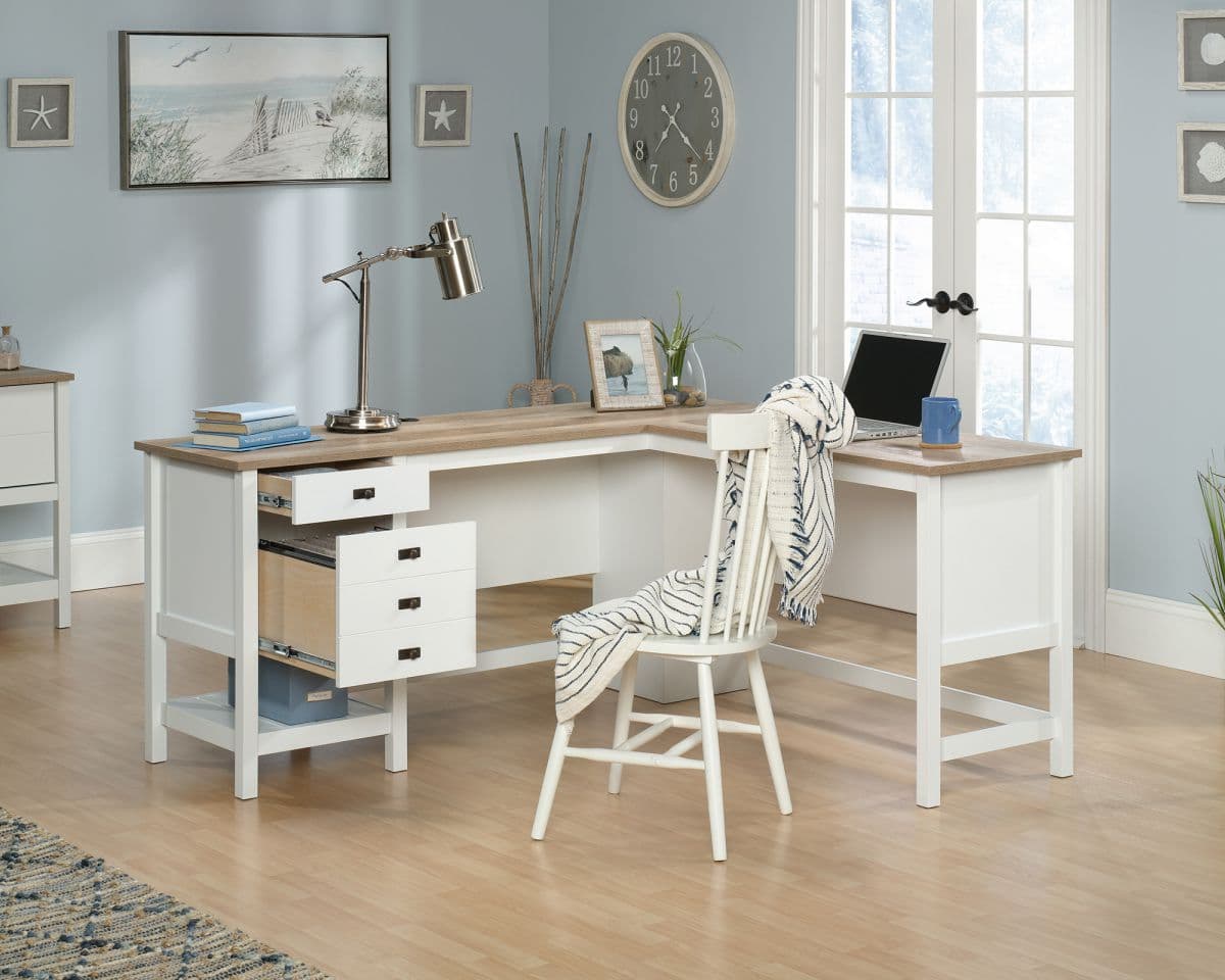 a desk with a chair and a laptop on it