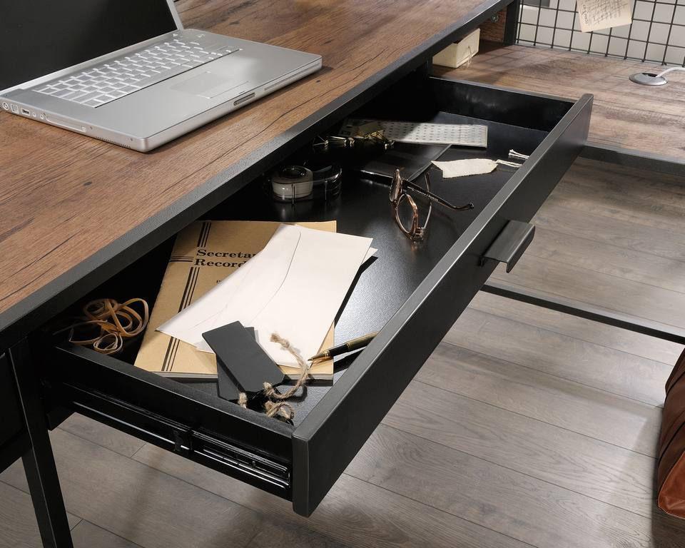 a laptop computer sitting on top of a wooden desk