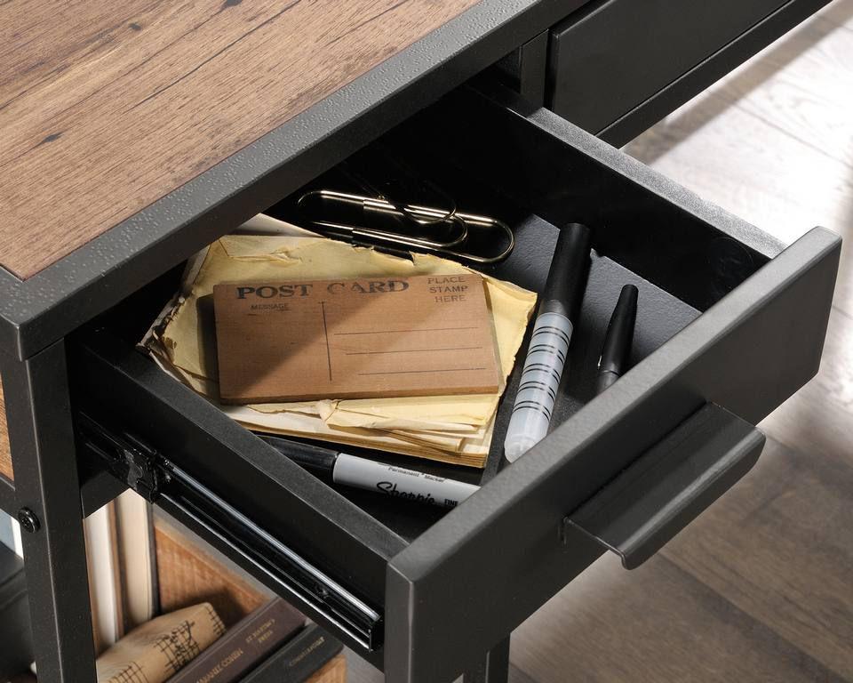 a drawer with a notepad, pen, and a pair of scissors