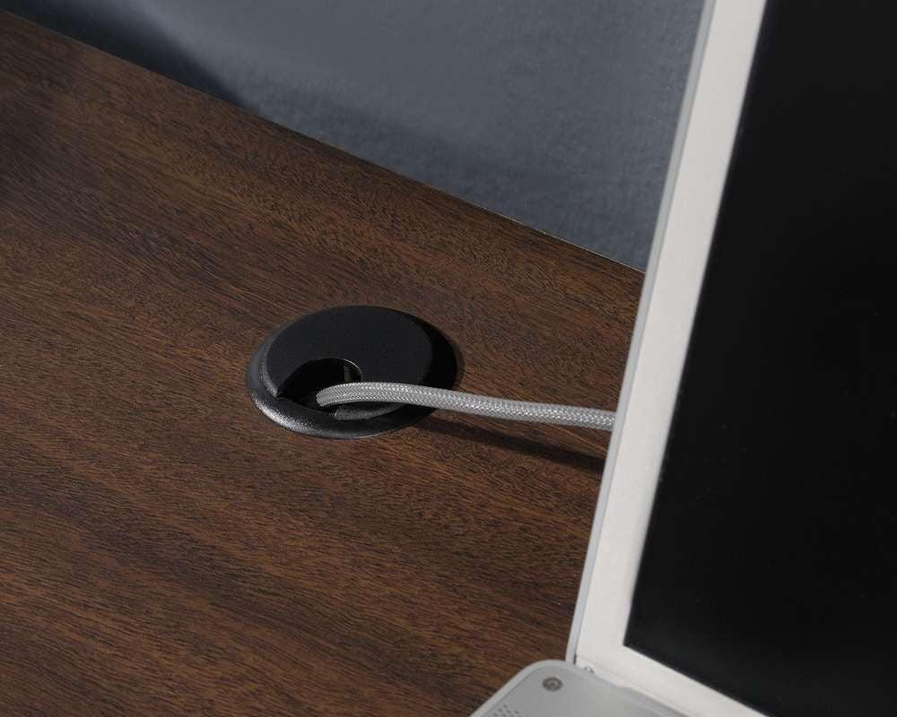 a computer monitor sitting on top of a wooden desk