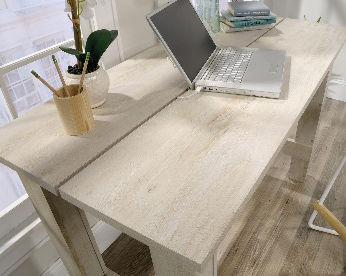 a laptop computer sitting on top of a wooden desk