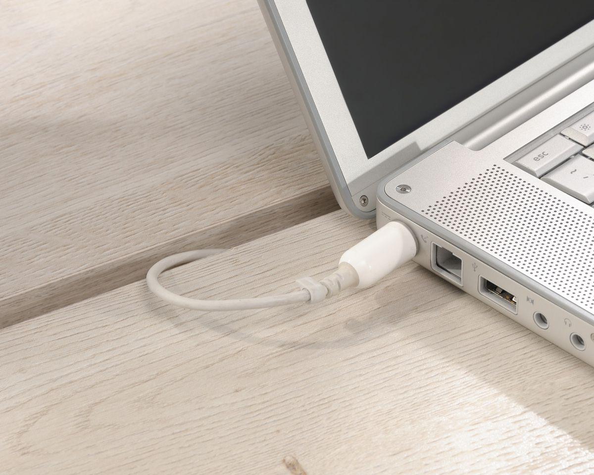 a laptop with a white cord plugged into it