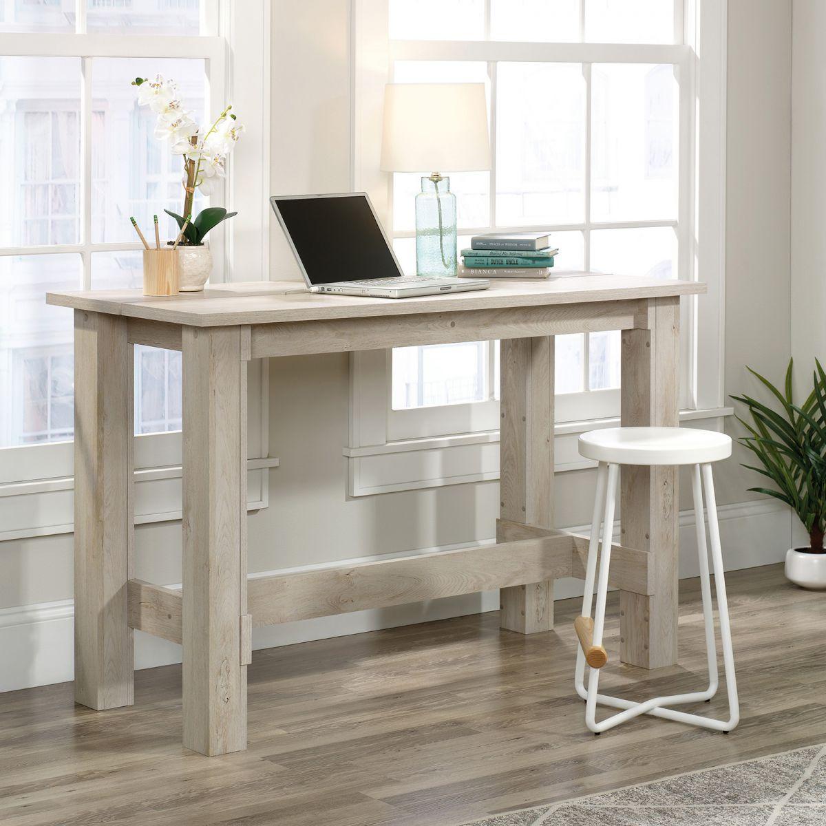 a desk with a laptop on top of it