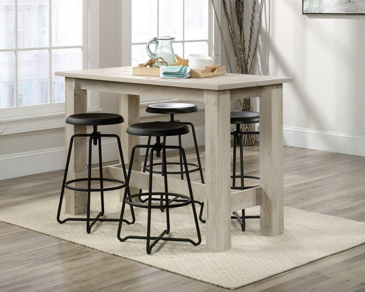 a kitchen table with four stools in front of it