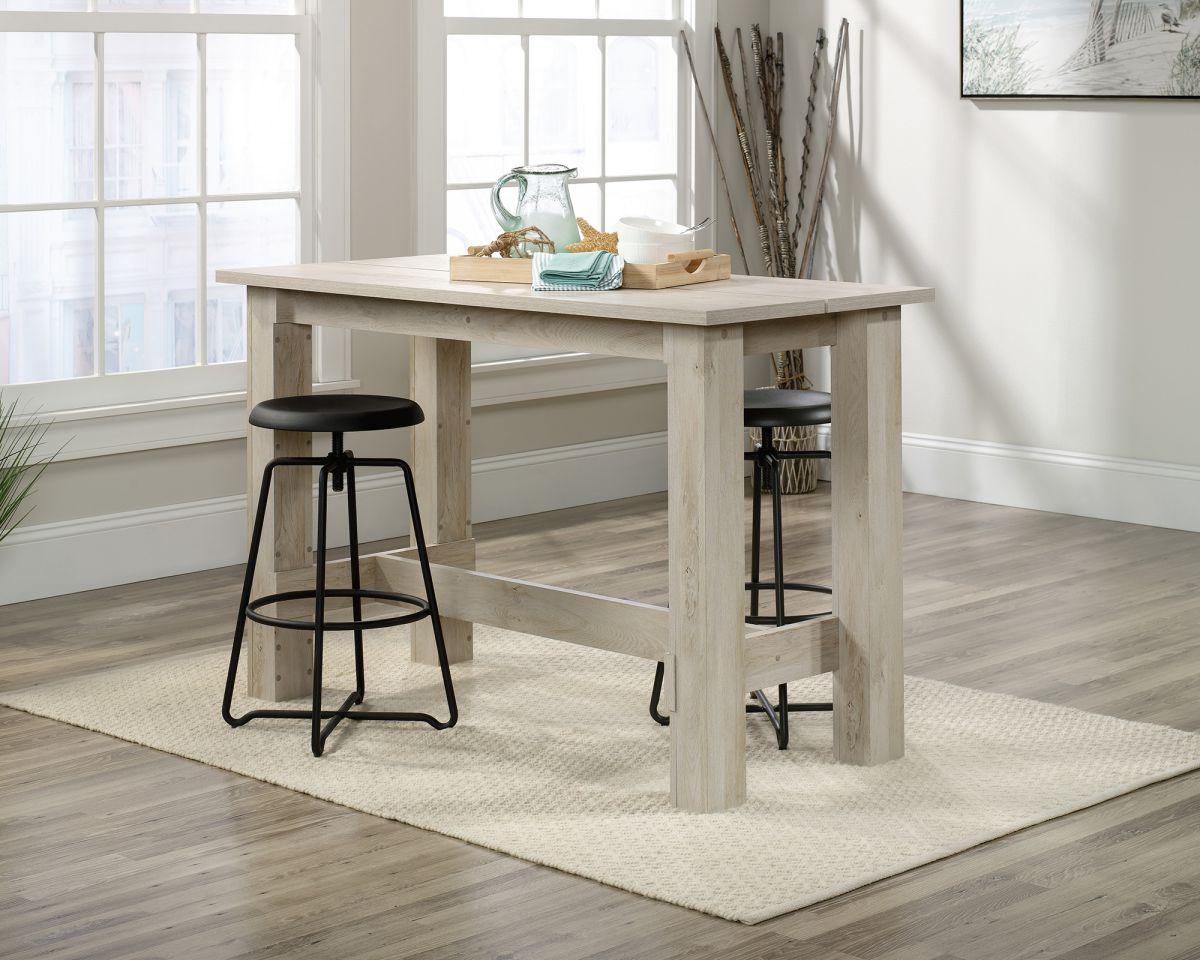 a kitchen table with two stools in front of it