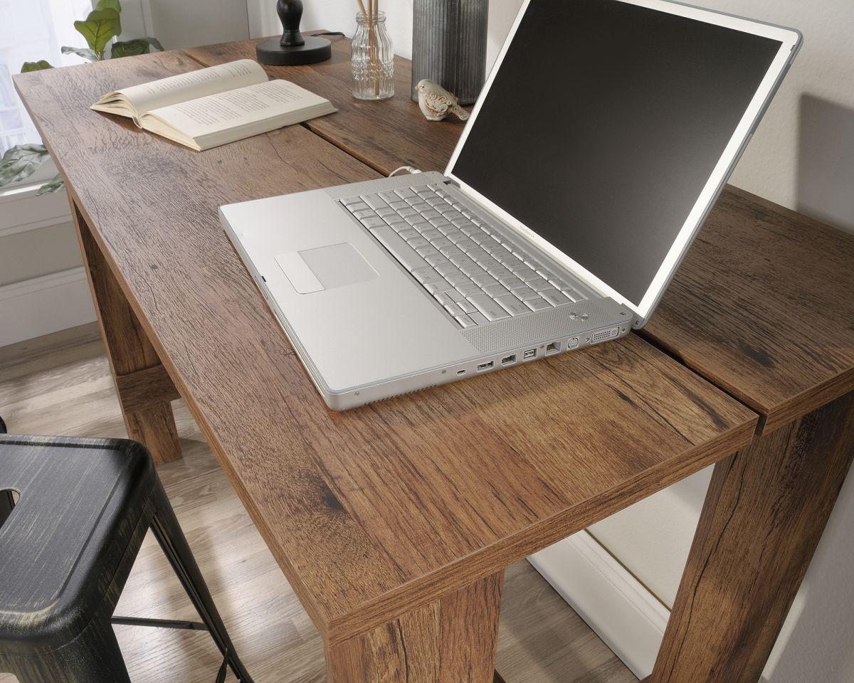 a laptop computer sitting on top of a wooden desk