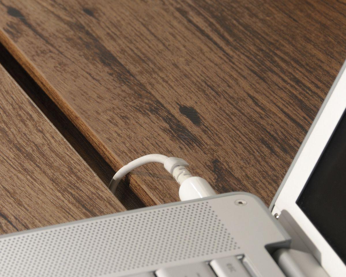 a laptop computer sitting on top of a wooden desk