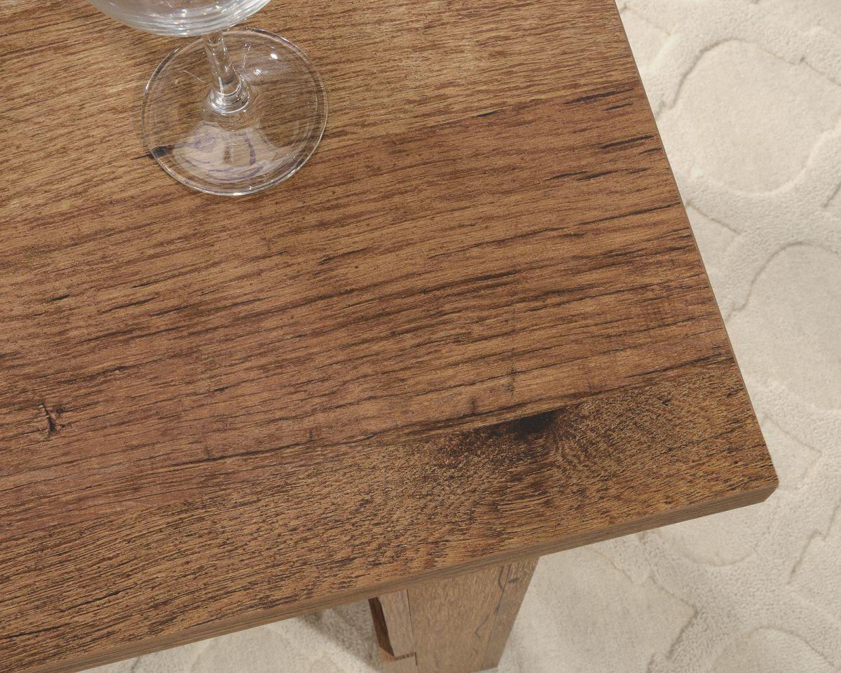 a wine glass sitting on top of a wooden table