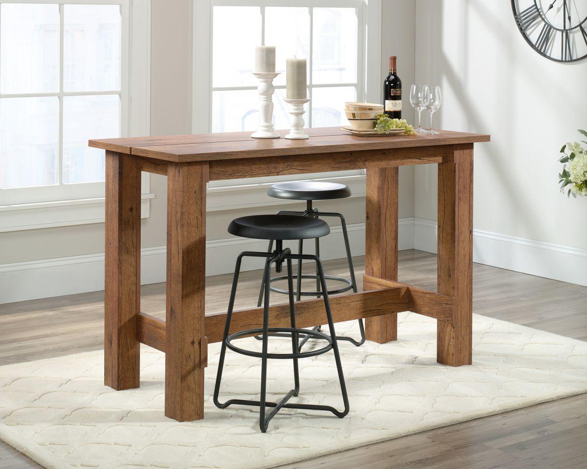 a kitchen table with two stools and a wine bottle