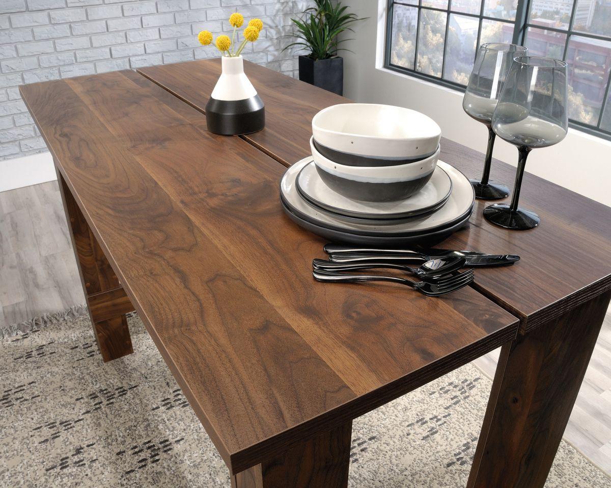 a wooden table with plates and utensils on it