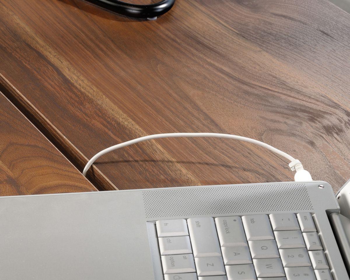 a laptop computer sitting on top of a wooden desk