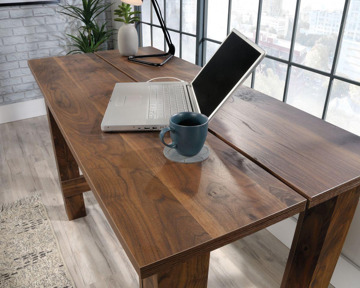 a laptop computer sitting on top of a wooden desk