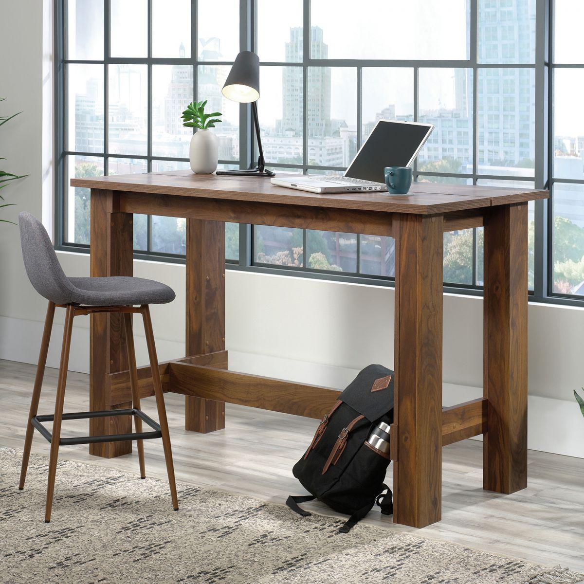 a desk with a laptop and a backpack on it