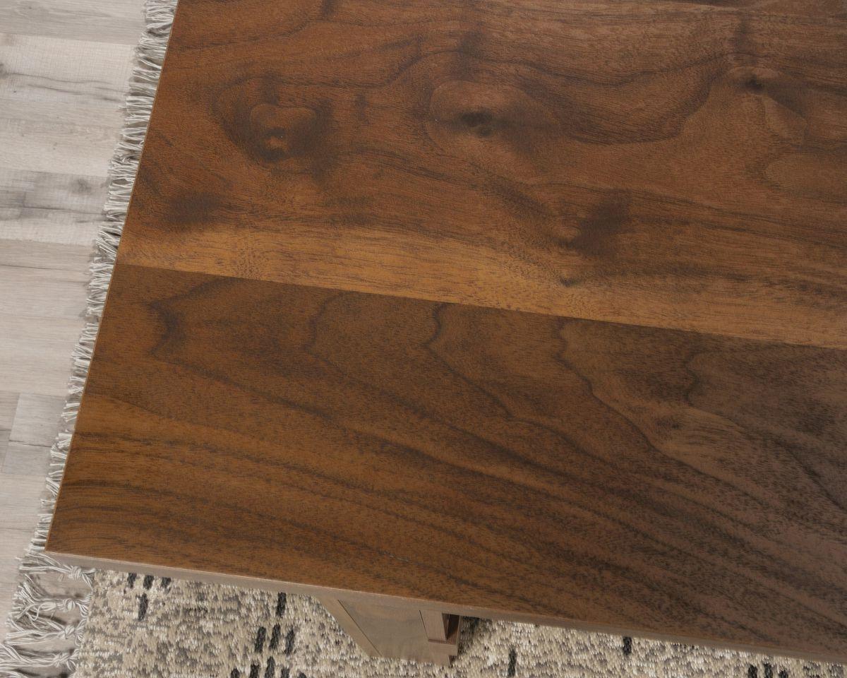 a close up of a wooden table on a rug