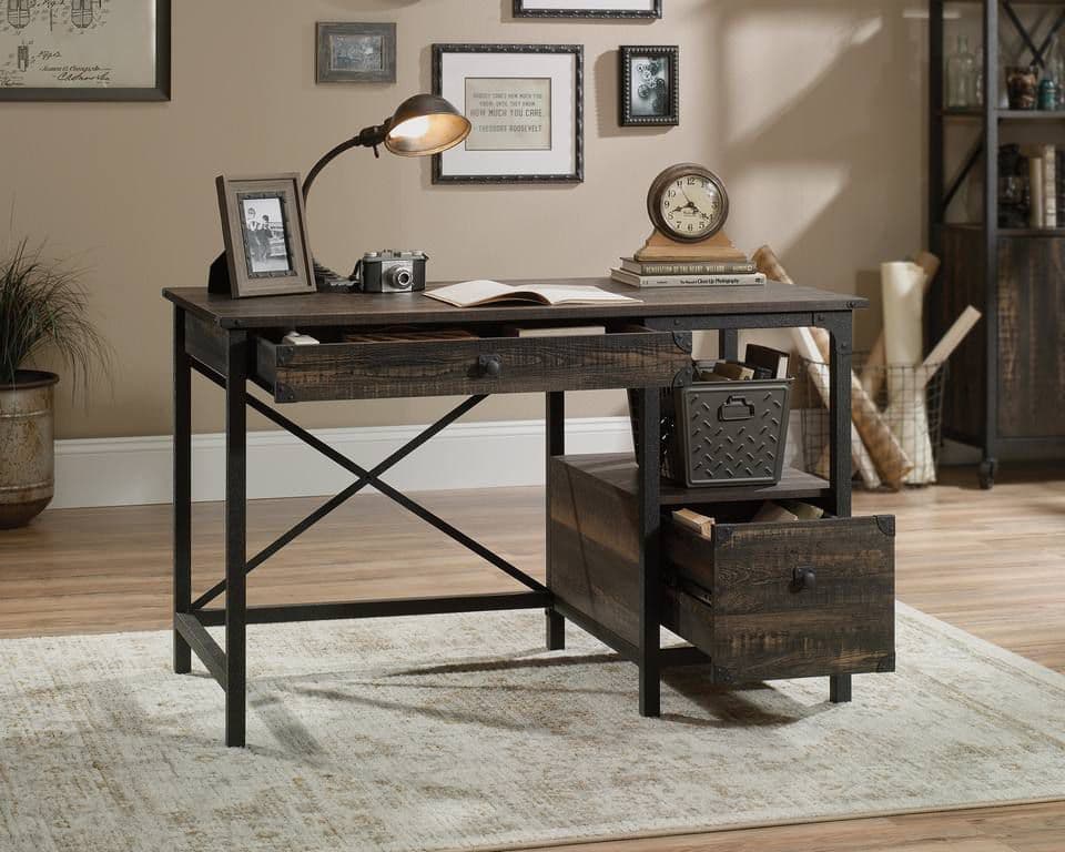 a desk with a lamp and a book on it