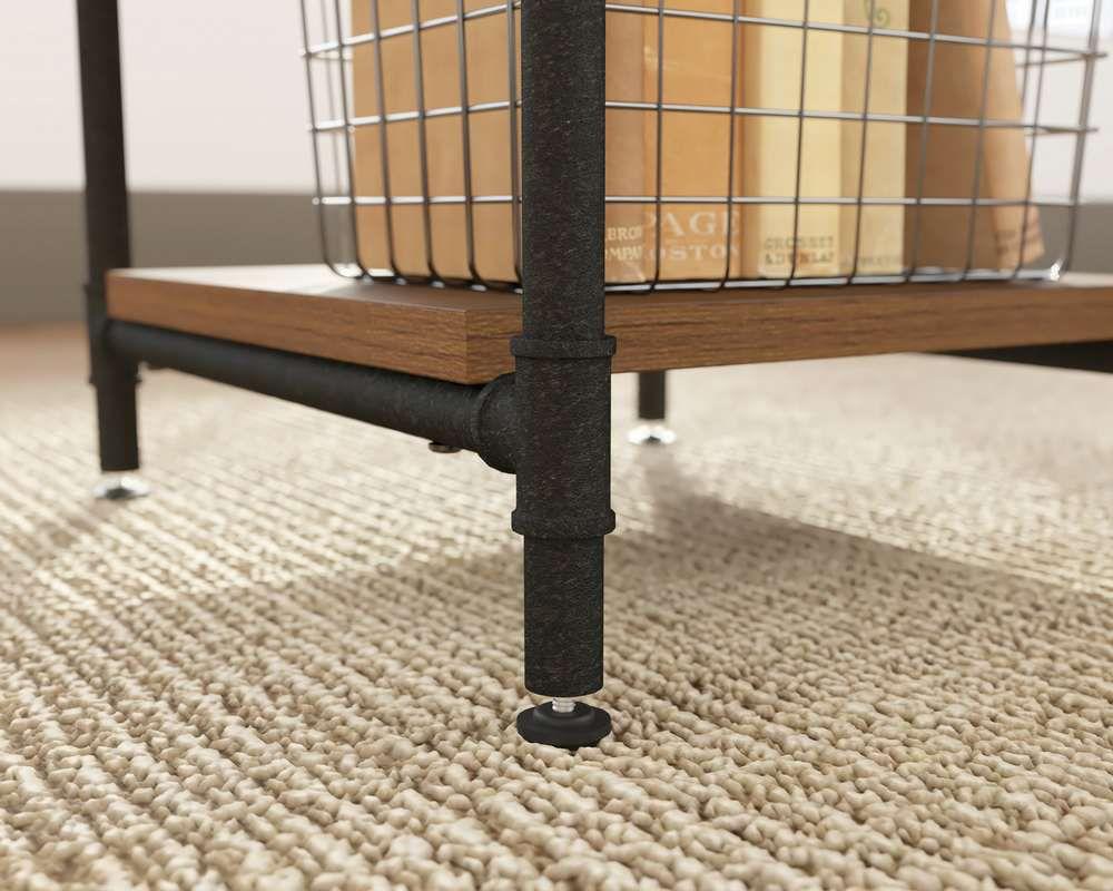 a metal basket sitting on top of a wooden table