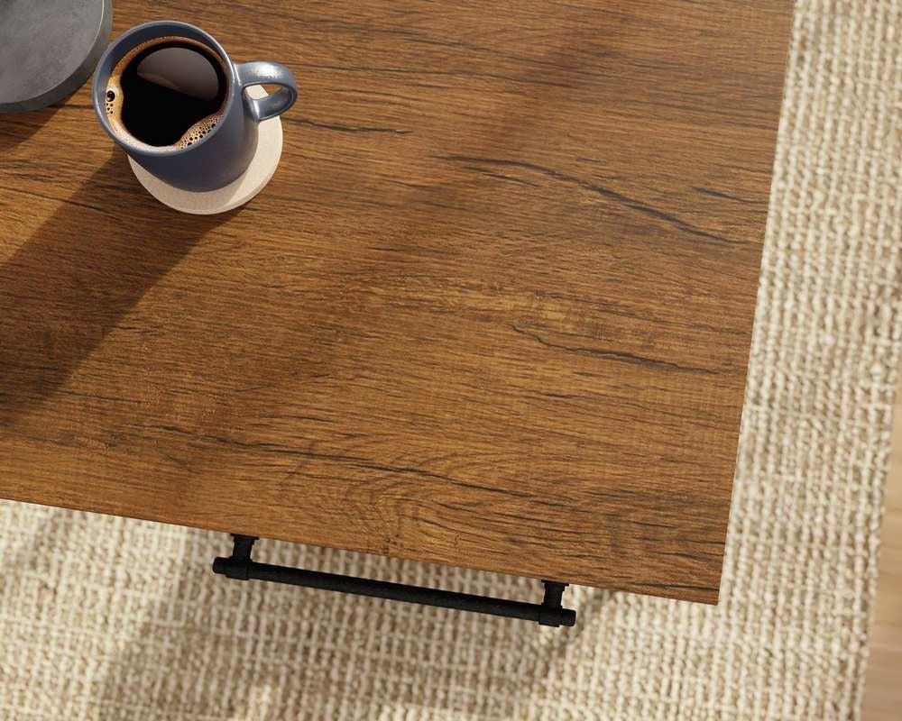 a cup of coffee sitting on top of a wooden table