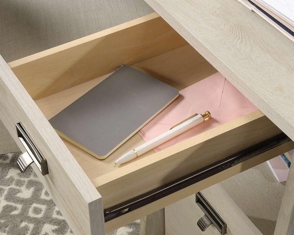 a desk with a pen, notebook and a notebook on it