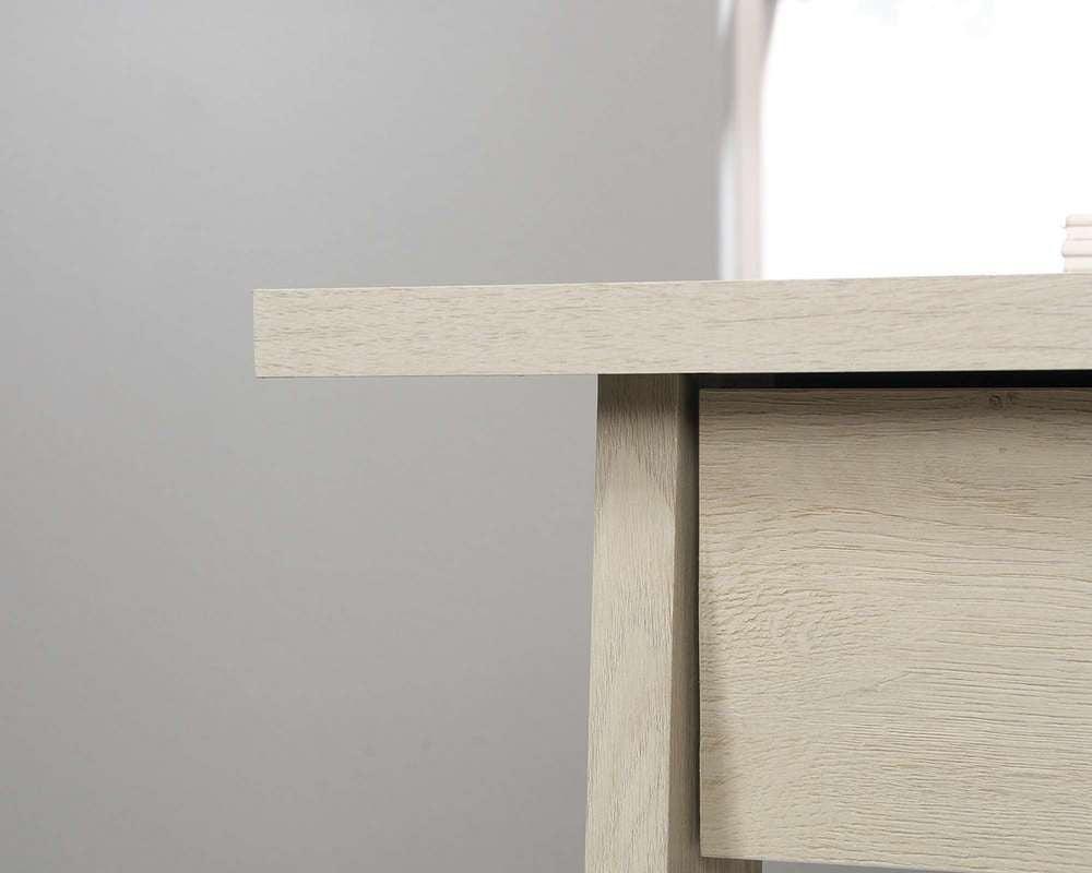 a close up of a wooden table with a window in the background