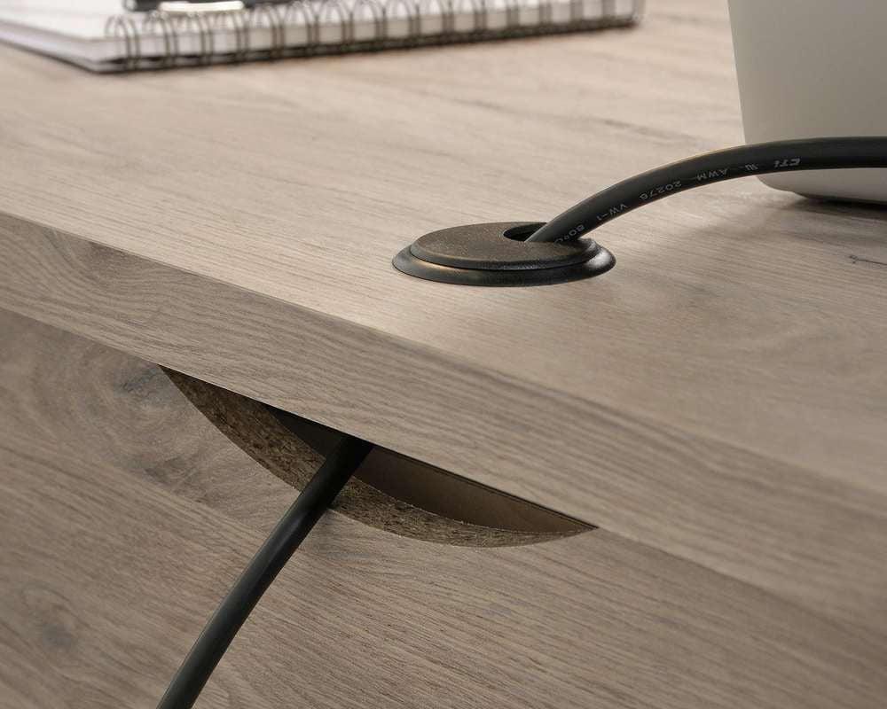 a laptop computer sitting on top of a wooden desk