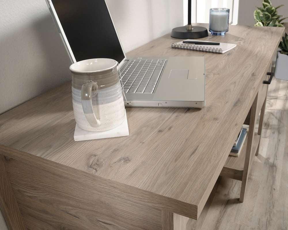 a laptop computer sitting on top of a wooden desk