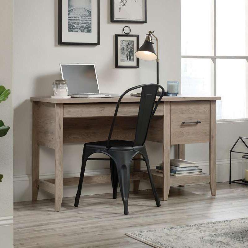 a desk with a chair and a laptop on it